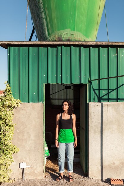A medium shot of a Banco Agrario branch office in a rural Colombian town. People are seen entering and exiting, and banners promoting agricultural loans are visible. The image suggests accessibility and support for local farmers.