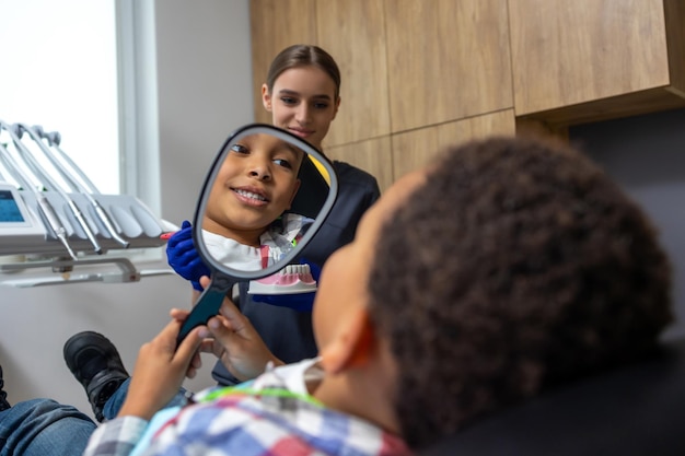 A modern dental office in Medellin, Colombia, with a happy patient showing off their bright, new smile, highlighting the country's growing reputation for quality and affordable dental tourism.