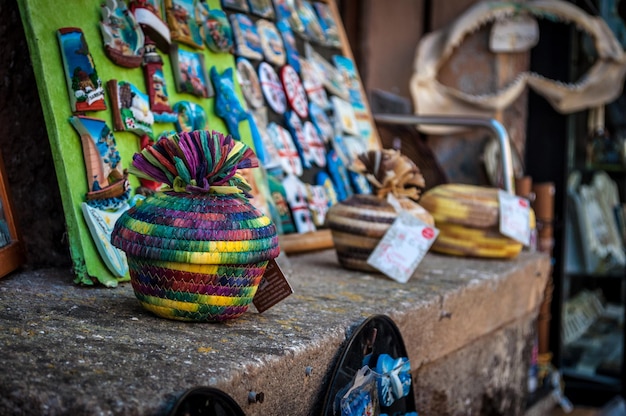 A bustling marketplace scene in Cartagena, Colombia, with vendors selling colorful crafts and fresh produce, showcasing the local culture and vibrant atmosphere.
