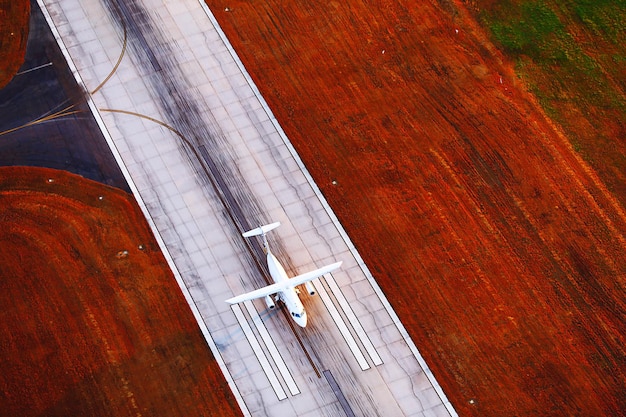 Aerial view of a cargo plane landing at a modern airport in Bogotá, Colombia, with a cityscape in the background. The image should emphasize the connectivity and infrastructure supporting e-commerce logistics.
