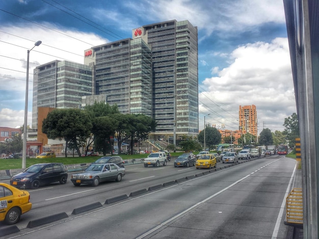 A modern office building in Bogotá, with a busy street scene in front.