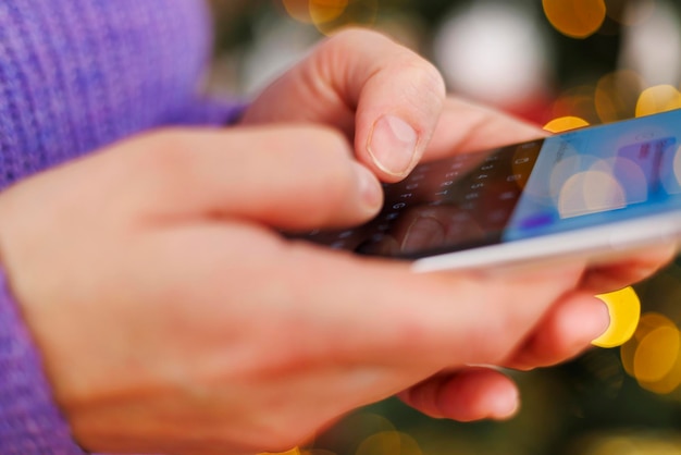 A person using a banking app on their cell phone, checking their savings account balance with a visible interest rate displayed.