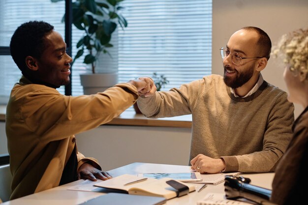 A person shaking hands with a financial advisor, symbolizing debt negotiation and financial recovery.