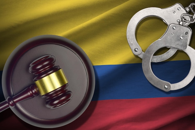 A gavel hitting a sound block with Colombian flag in the background. Symbolizing legal decisions and justice in Colombia.