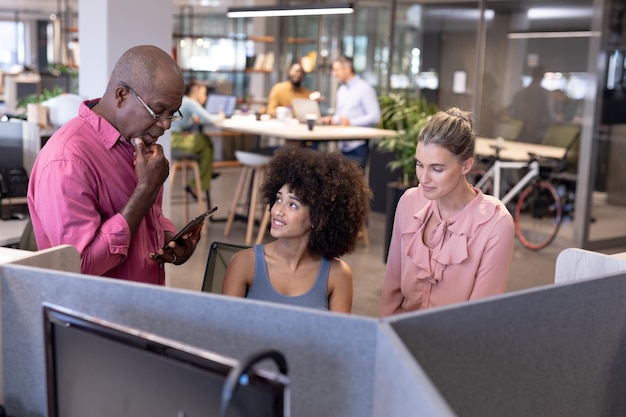 A diverse team of employees working collaboratively in a modern office space in Colombia. The image emphasizes the importance of teamwork and a positive work environment.