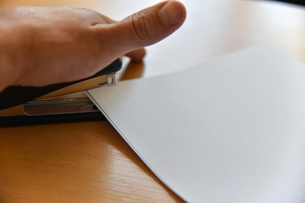 A hand holding a pen, filling out a government application form with a focus on the sections related to small business grants and subsidies. The overall tone represents meticulous preparation and attention to detail.